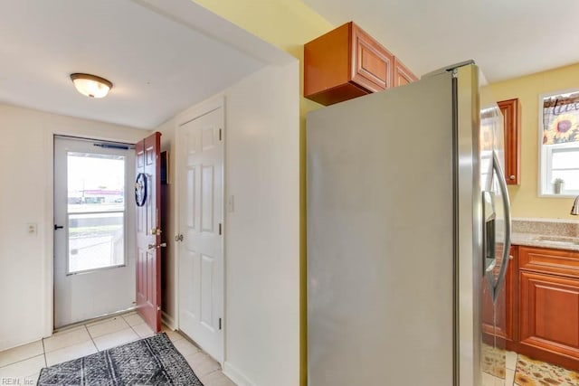 interior space featuring plenty of natural light, sink, and light tile patterned floors