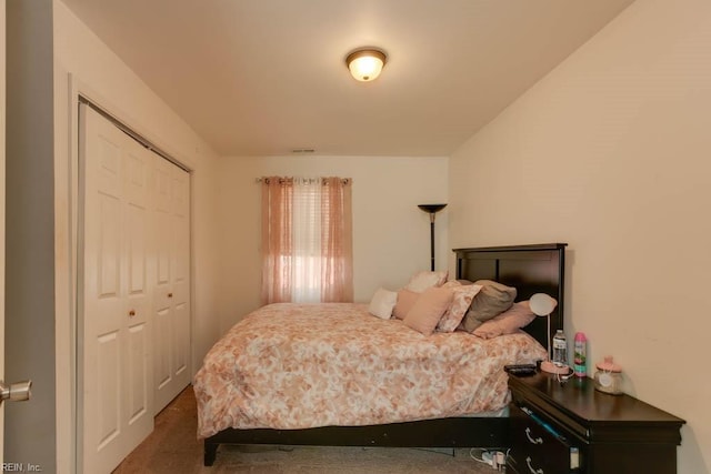 bedroom with dark carpet and a closet