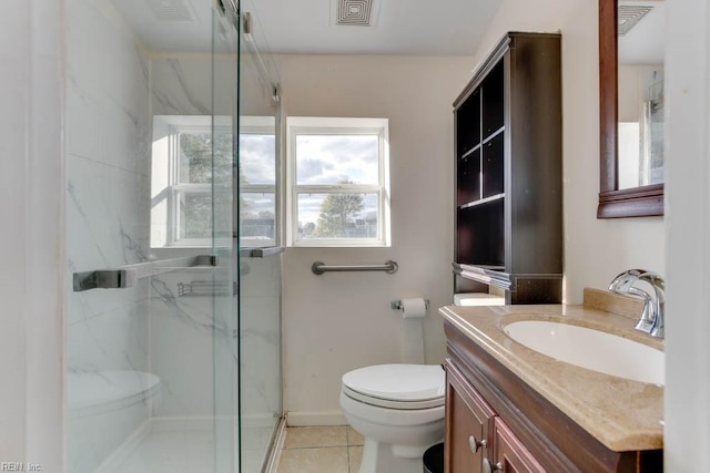 bathroom with tile patterned flooring, vanity, toilet, and a shower with shower door