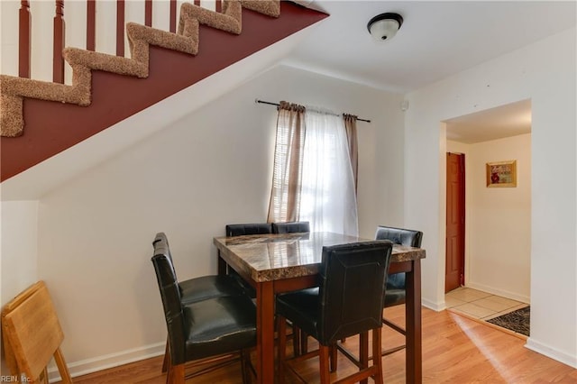 dining space with light hardwood / wood-style floors