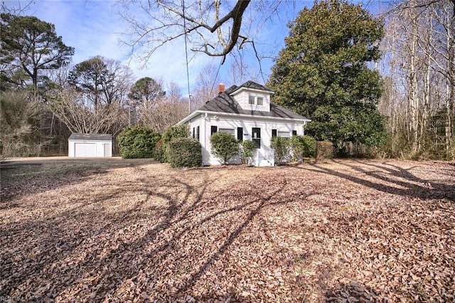 view of home's exterior featuring a garage and an outdoor structure