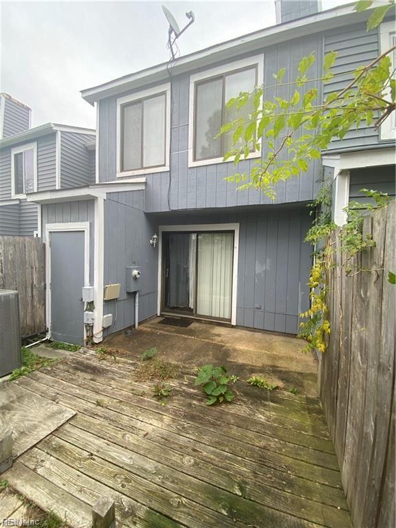 rear view of house with cooling unit and a deck