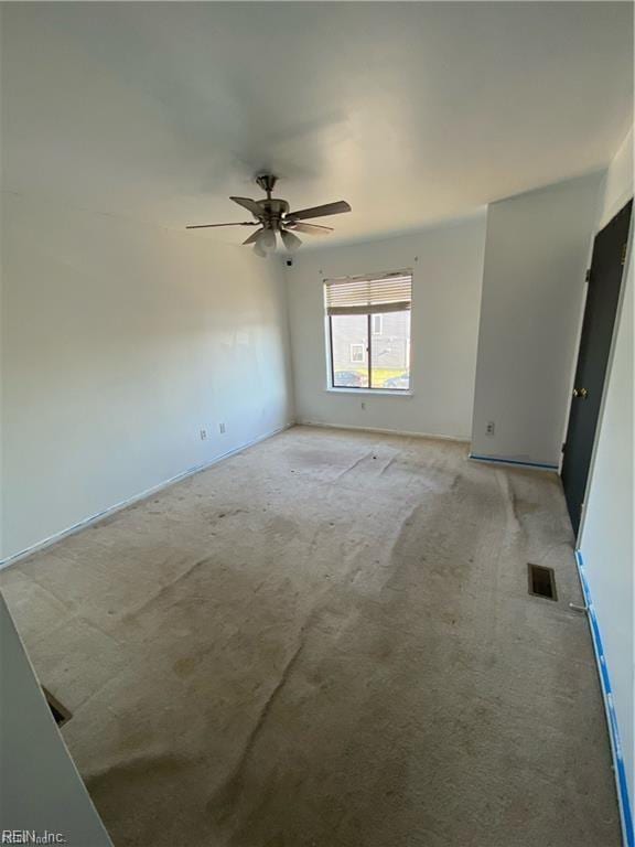 carpeted empty room with ceiling fan