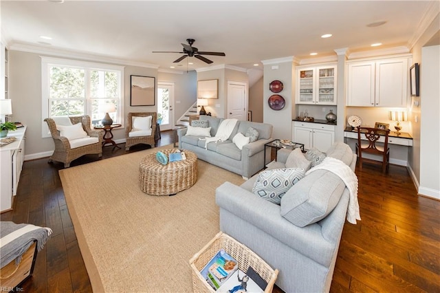 living room featuring ornamental molding, dark hardwood / wood-style flooring, and built in desk