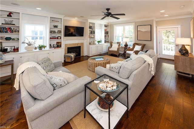 living room featuring crown molding, a wealth of natural light, dark hardwood / wood-style floors, and ceiling fan