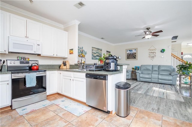 kitchen featuring white cabinetry, appliances with stainless steel finishes, crown molding, and kitchen peninsula