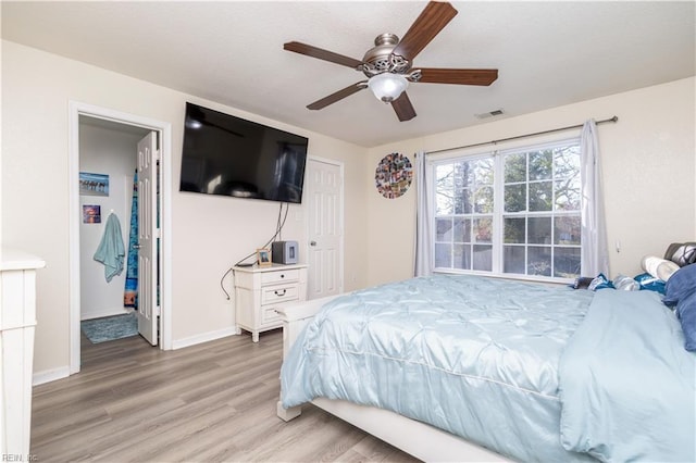 bedroom with hardwood / wood-style floors and ceiling fan