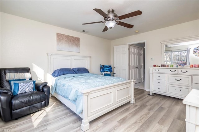 bedroom with ceiling fan and light hardwood / wood-style floors