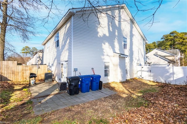 back of house featuring central AC and a patio