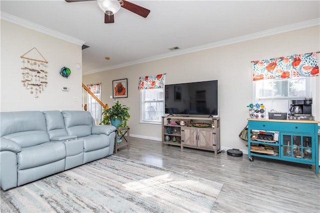 living room featuring crown molding, ceiling fan, and hardwood / wood-style flooring