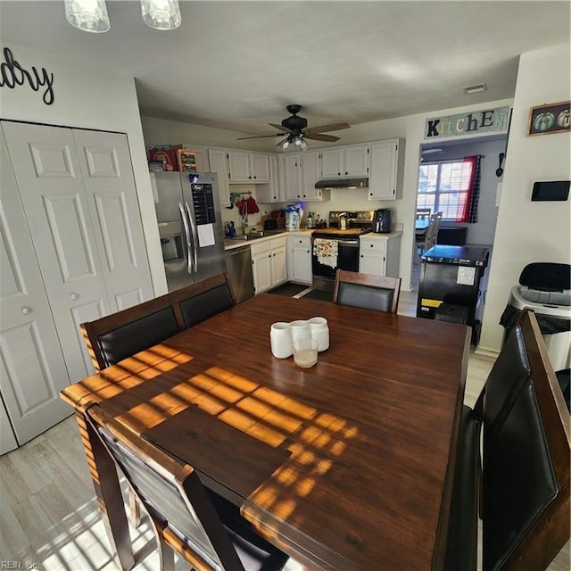 dining room with ceiling fan and light hardwood / wood-style floors