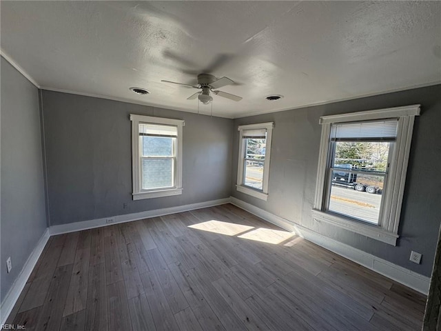 unfurnished room with wood-type flooring, a textured ceiling, and ceiling fan