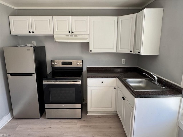 kitchen with appliances with stainless steel finishes, sink, white cabinets, and light hardwood / wood-style floors