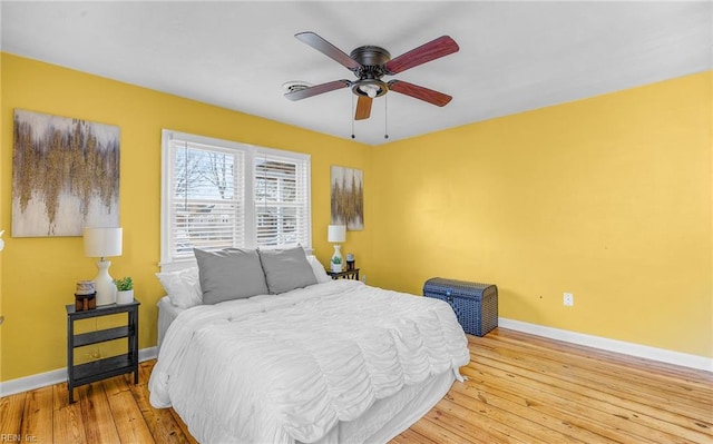 bedroom with ceiling fan and light hardwood / wood-style floors