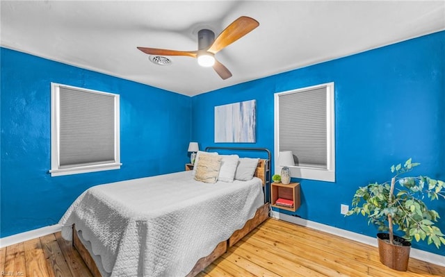 bedroom featuring hardwood / wood-style floors and ceiling fan