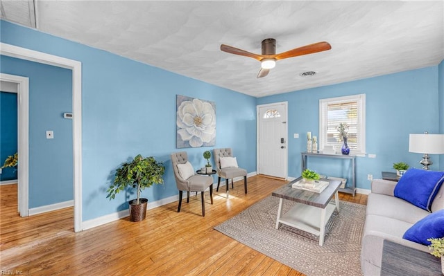 living room featuring ceiling fan and light wood-type flooring