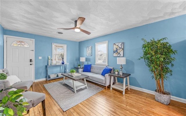 living room with ceiling fan and light wood-type flooring