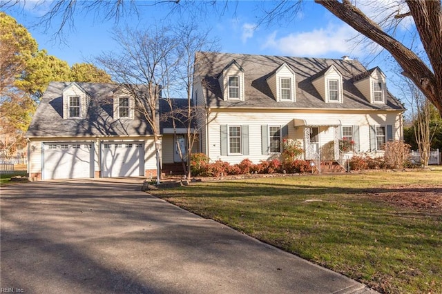 new england style home with a garage and a front lawn