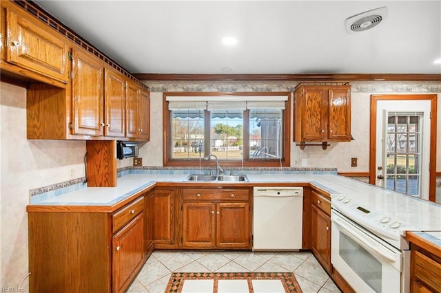 kitchen featuring sink, white appliances, kitchen peninsula, and light tile patterned flooring