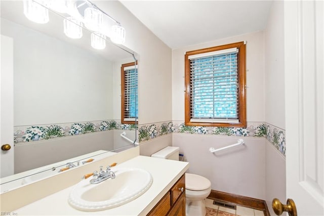 bathroom featuring vanity, tile patterned floors, and toilet