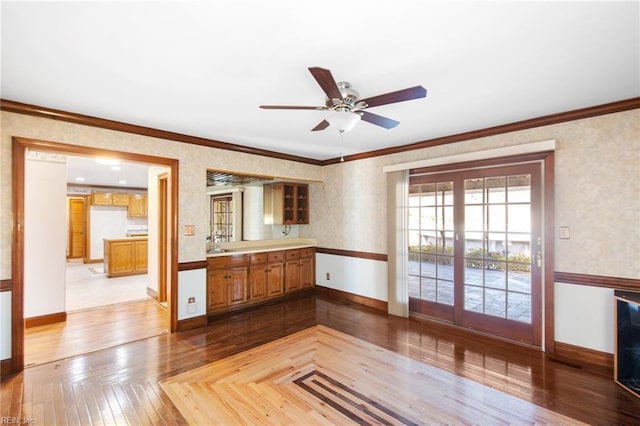 kitchen with crown molding, ceiling fan, and light parquet floors