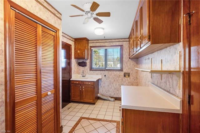 kitchen featuring ceiling fan, sink, and light tile patterned floors