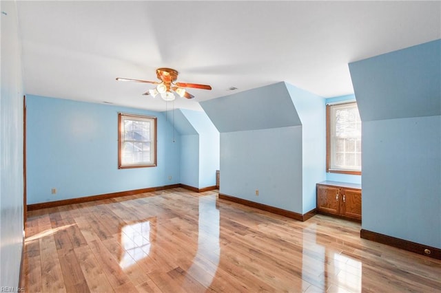 additional living space featuring lofted ceiling, ceiling fan, and light wood-type flooring