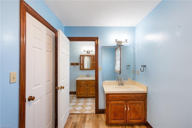 bathroom with vanity and hardwood / wood-style floors