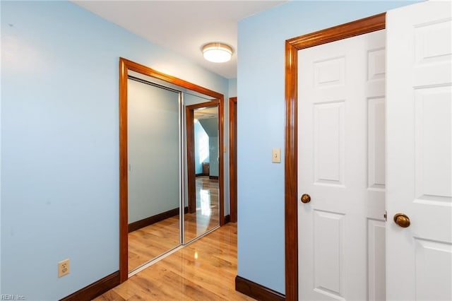 hallway with light hardwood / wood-style flooring