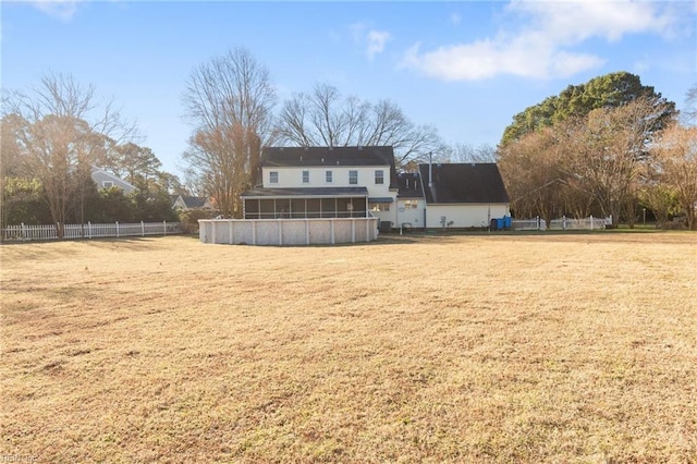 back of house featuring a yard