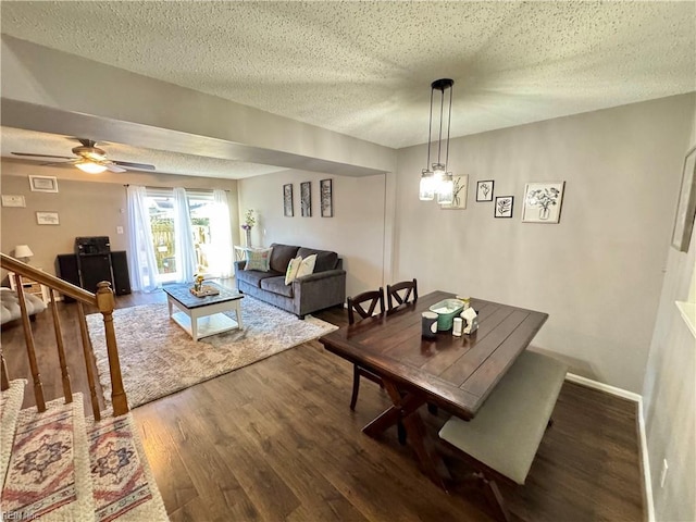 dining area with ceiling fan, hardwood / wood-style floors, and a textured ceiling