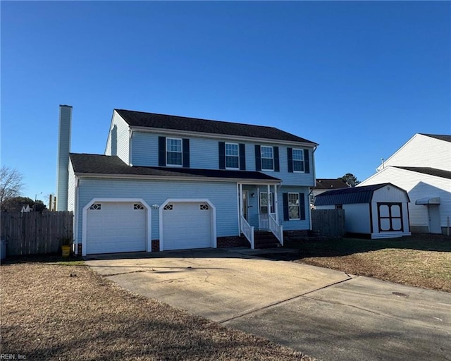 view of front of property featuring a garage and a storage shed