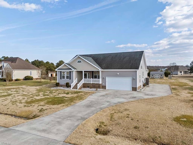 view of front of home with a porch, a garage, and a front yard