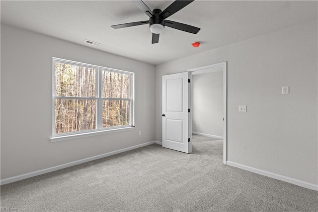 unfurnished bedroom with ceiling fan and light colored carpet