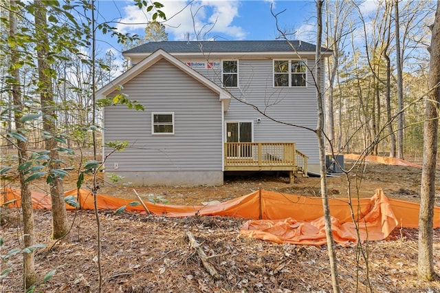 rear view of house featuring a wooden deck