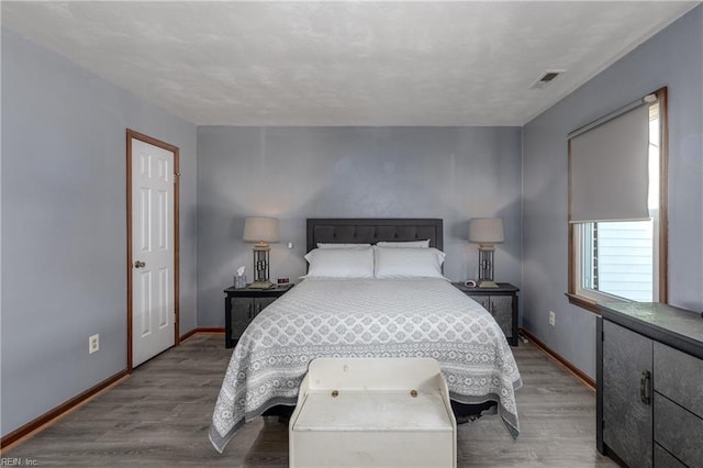 bedroom with hardwood / wood-style floors