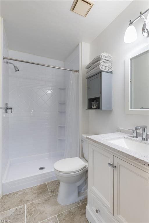 bathroom featuring vanity, toilet, and curtained shower