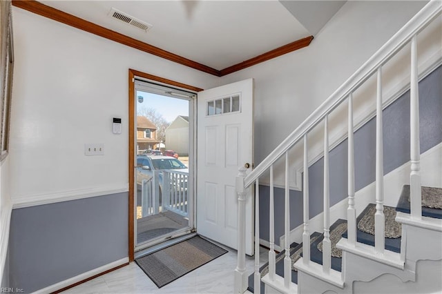 entryway featuring ornamental molding