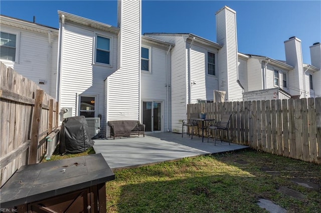 back of house featuring a yard and a patio area