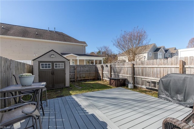 deck featuring area for grilling and a storage unit