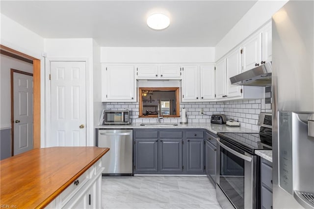 kitchen featuring white cabinetry, stainless steel appliances, and sink