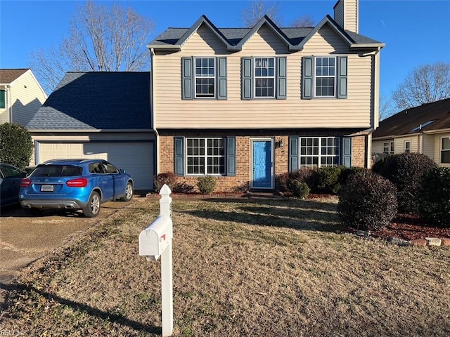 view of front of property featuring a garage and a front lawn