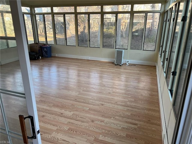 unfurnished sunroom with radiator