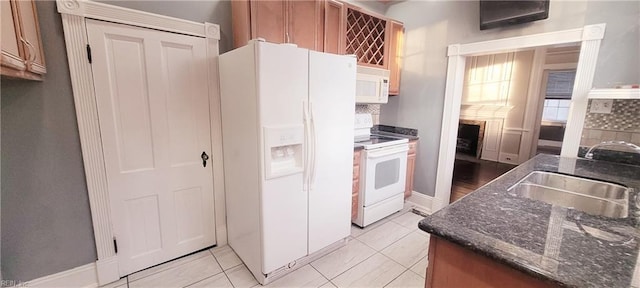 kitchen featuring sink, white appliances, and light tile patterned floors