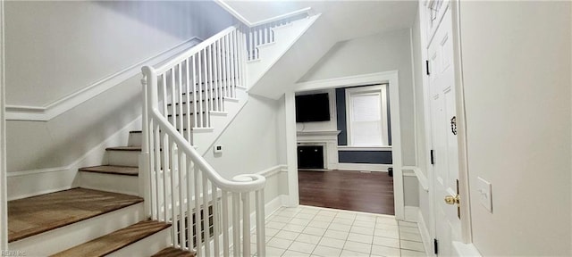 stairs featuring tile patterned flooring