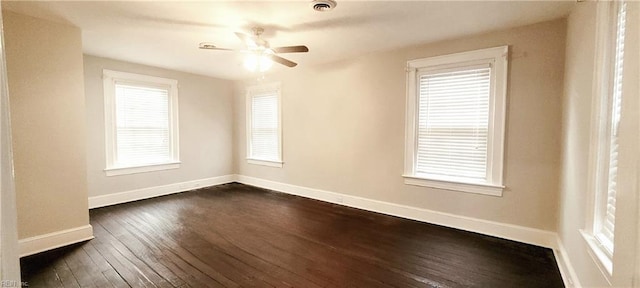 unfurnished room with dark hardwood / wood-style flooring and ceiling fan