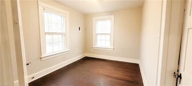 spare room with dark hardwood / wood-style flooring