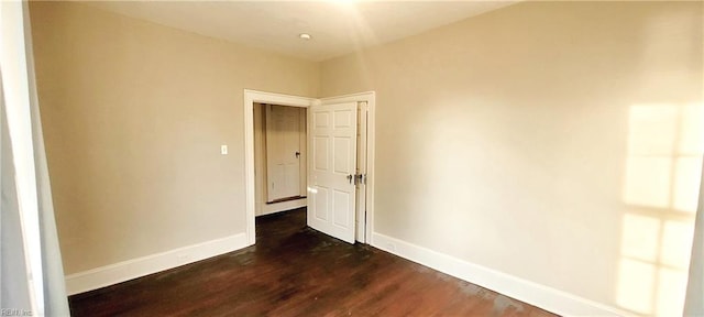 unfurnished room featuring dark hardwood / wood-style flooring