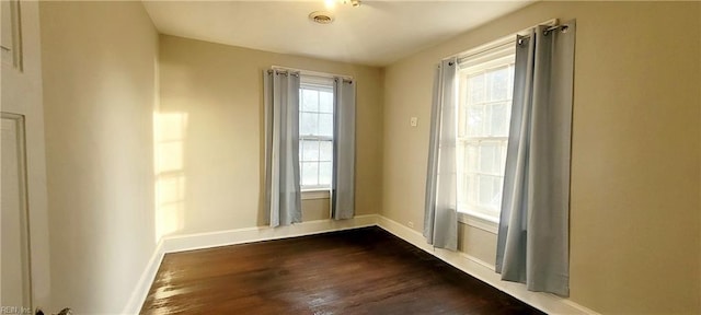 spare room featuring dark wood-type flooring