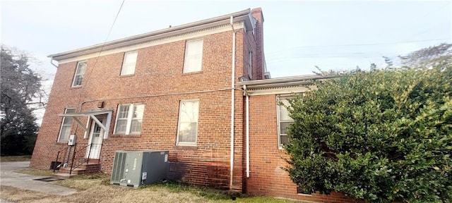 view of side of home featuring cooling unit